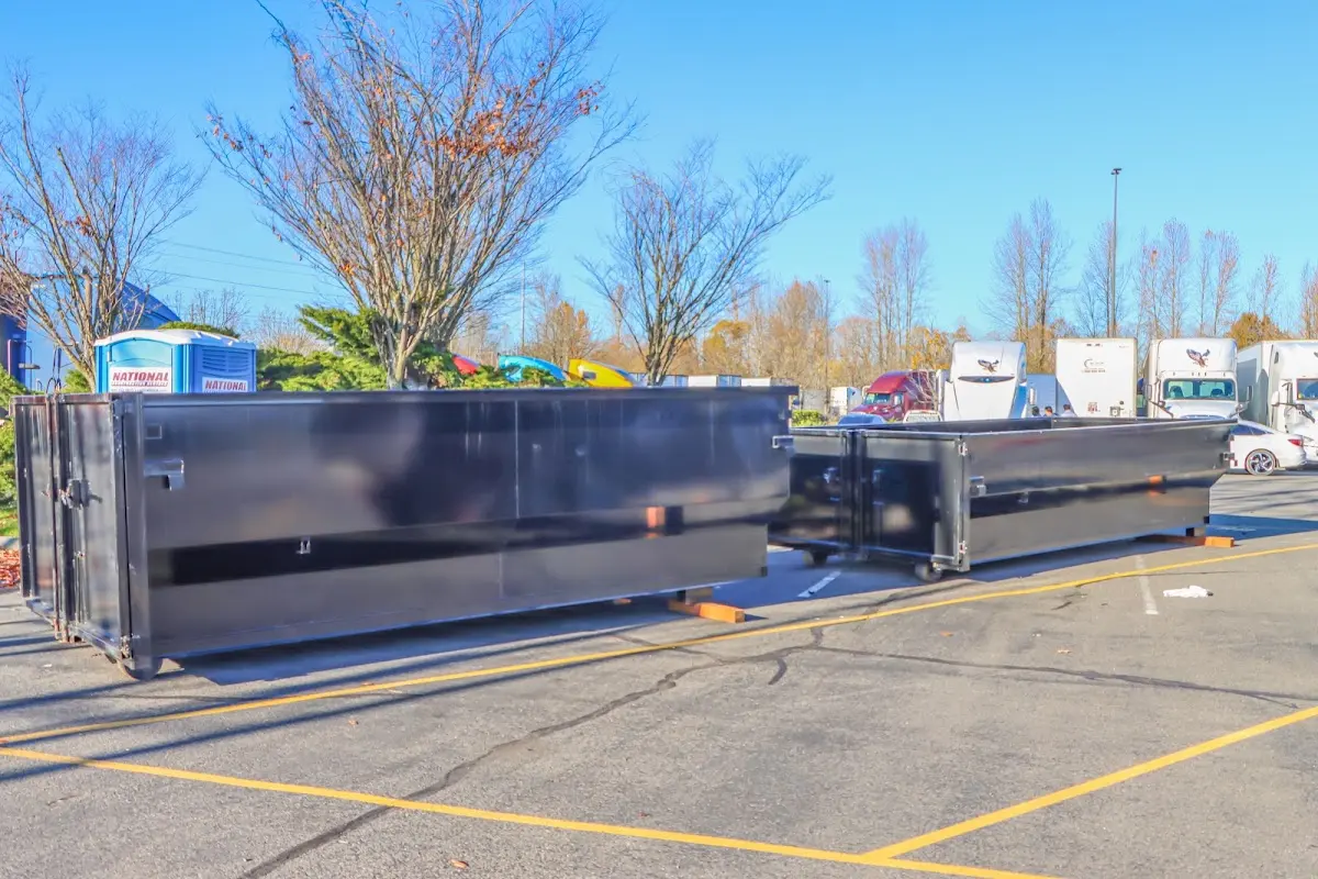 Professional dumpster rental service with roll-off container on residential driveway in McKinney